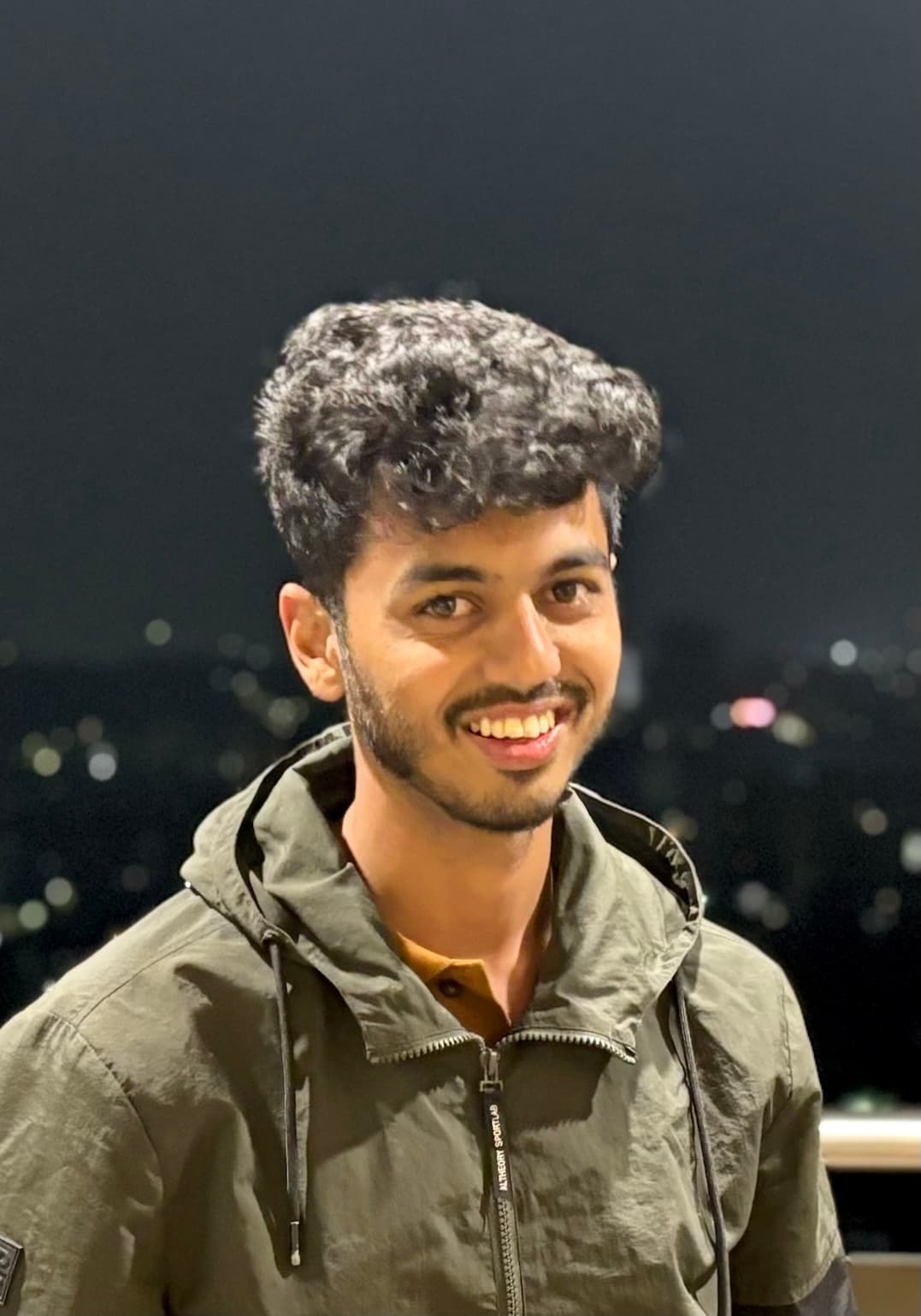 Pavan Patil smiling outdoors at night
